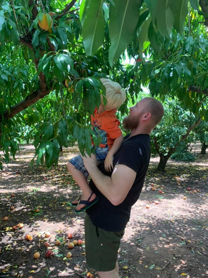 Chad and Declan peach picking