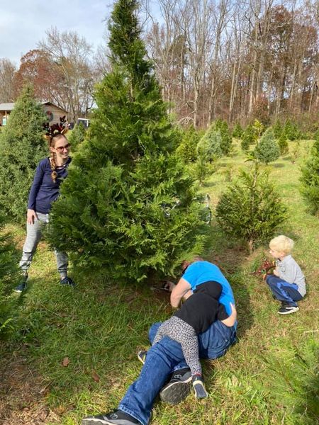 Kason "helping" Chad cut down the perfect tree with Jamie and Declan