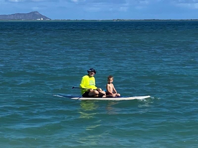 Willy and Hudson on paddleboard at Kapilina